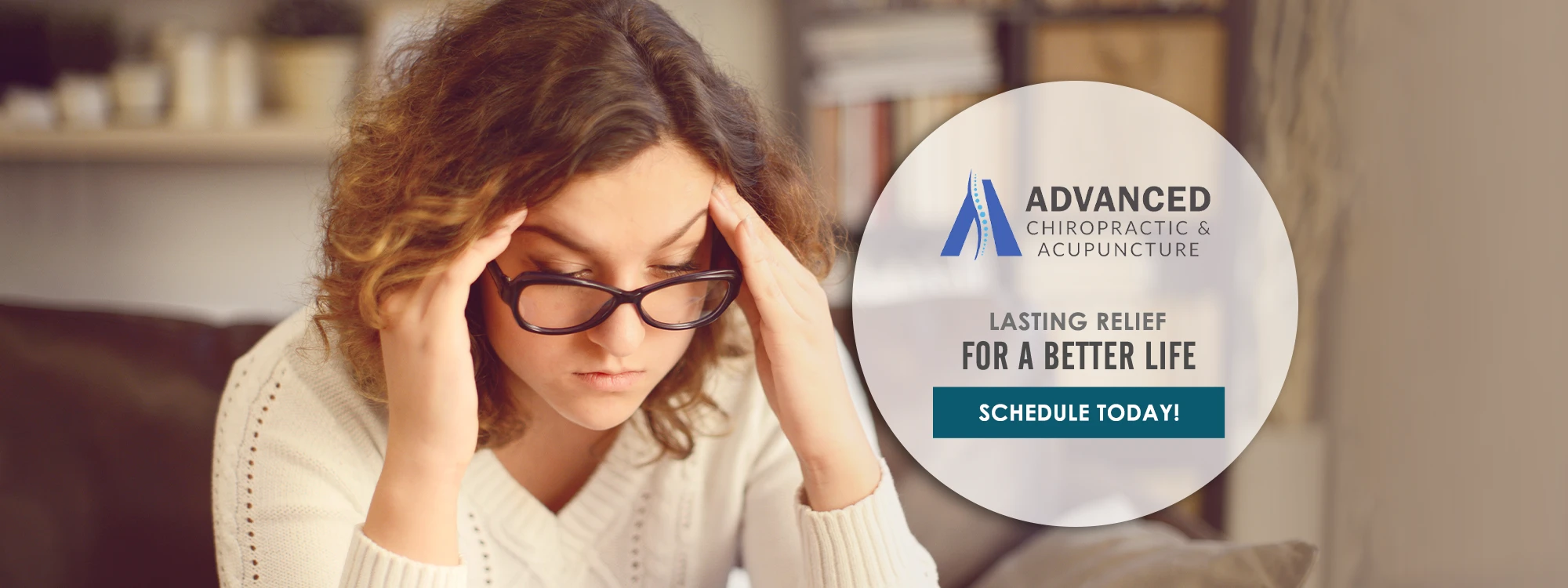 A woman with a headache holding her head in her hands