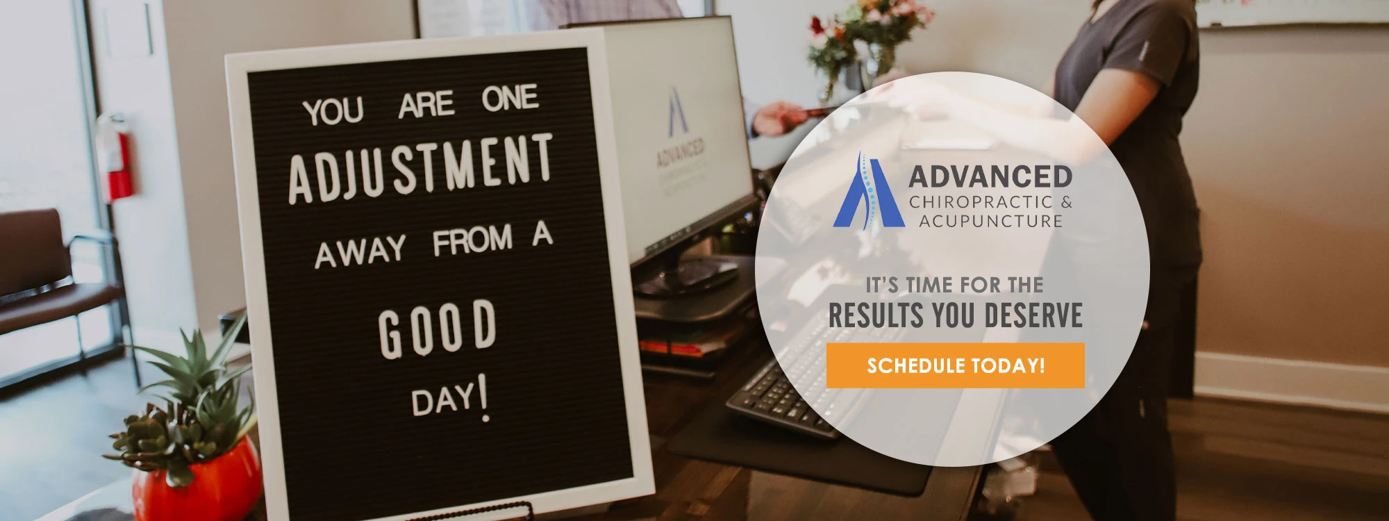 A sign at the front desk reading "You are One Adjustment Away from a Good Day"