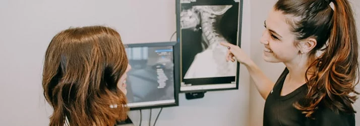 Dr. Cassie Meylor Lourens reviewing x-rays with a patient